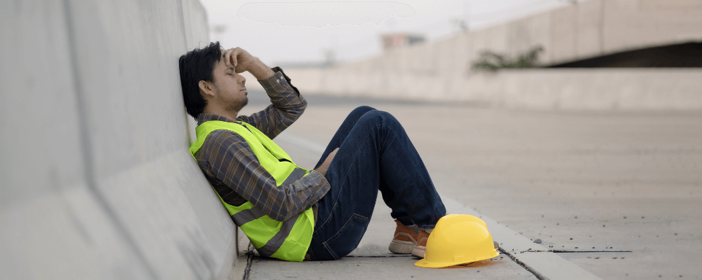 image of an exhausted or tired construction worker taking a break